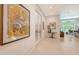 Bright hallway featuring tile floors, art, and views of the living space at 2135 Hyde Park St, Sarasota, FL 34239