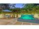 Beautiful backyard patio with a mosaic tiled hot tub, a waterfall, and dining area for outdoor enjoyment at 2135 Hyde Park St, Sarasota, FL 34239
