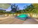 Beautiful outdoor patio with mosaic tiled hot tub featuring a waterfall and dining area surrounded by trees at 2135 Hyde Park St, Sarasota, FL 34239
