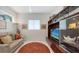 Comfortable living room with a brown rug, sofa, TV, and shelving at 2135 Hyde Park St, Sarasota, FL 34239