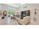 Bright living room features large windows, comfortable seating, and access to the backyard pool area at 2135 Hyde Park St, Sarasota, FL 34239