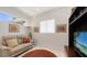 Comfortable living room with a brown rug, sofa, TV, and shelving at 2135 Hyde Park St, Sarasota, FL 34239