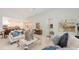 Bright living room features white tile flooring, modern decor, and seamless access to the kitchen at 2135 Hyde Park St, Sarasota, FL 34239