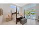 Bright main bedroom with four poster bed and sliding glass doors to outdoor seating area at 2135 Hyde Park St, Sarasota, FL 34239