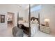 Bright main bedroom with four poster bed and access to an ensuite bathroom at 2135 Hyde Park St, Sarasota, FL 34239