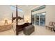 Bright main bedroom with four poster bed and sliding glass doors to outdoor seating area at 2135 Hyde Park St, Sarasota, FL 34239
