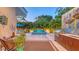 Outdoor area showcasing a unique water feature, patio furniture, a built-in grill, and lush landscaping at 2135 Hyde Park St, Sarasota, FL 34239