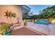 Outdoor patio featuring a tranquil water feature, manicured landscaping, and comfortable seating area at 2135 Hyde Park St, Sarasota, FL 34239