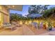 Beautiful outdoor patio area, featuring lounge chairs, dining table with seating, and lush tropical landscaping at 2135 Hyde Park St, Sarasota, FL 34239
