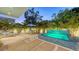 Outdoor patio with hot tub, lounge chairs, and table with blue umbrella for a cool backyard experience at 2135 Hyde Park St, Sarasota, FL 34239