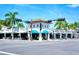 A street view of the community restaurants in a lovely neighborhood with palm trees at 2135 Hyde Park St, Sarasota, FL 34239