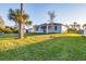 Large backyard with a covered patio and a well-manicured lawn at 2258 Margaret Ln, North Port, FL 34286