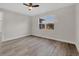 Bedroom showcasing wood-look flooring, ceiling fan, and window to the backyard at 2258 Margaret Ln, North Port, FL 34286