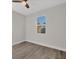 Bedroom with a ceiling fan, wood-look floors, and natural light from the window at 2258 Margaret Ln, North Port, FL 34286