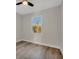 Bright bedroom features wood-look flooring and a modern ceiling fan and a window view at 2258 Margaret Ln, North Port, FL 34286