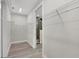 Walk-in closet with open wire shelving and a view into the ensuite bathroom at 2258 Margaret Ln, North Port, FL 34286