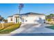 Beautiful home with a three-car garage and a concrete driveway under a bright sky at 2258 Margaret Ln, North Port, FL 34286