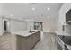 Modern kitchen featuring an island with sink, stainless steel appliances, and sliding glass doors at 2258 Margaret Ln, North Port, FL 34286