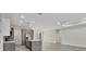 Open-concept kitchen with island sink, stainless steel appliances, and gray-toned flooring at 2258 Margaret Ln, North Port, FL 34286
