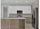 Well-equipped kitchen with a center island, stainless steel appliances, and sleek cabinetry at 2258 Margaret Ln, North Port, FL 34286