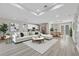 Bright, open-concept living space with modern furnishings, recessed lighting and wood-look flooring at 2258 Margaret Ln, North Port, FL 34286
