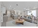 Modern living room featuring an open concept, recessed lighting, kitchen island, and wood-look floors at 2258 Margaret Ln, North Port, FL 34286