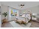 Serene bedroom with a large window, a wooden bed frame, and a ceiling fan at 2258 Margaret Ln, North Port, FL 34286
