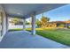 Covered patio showing the spacious backyard with green grass and other residences at 2258 Margaret Ln, North Port, FL 34286