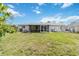 Expansive backyard with a screened patio, perfect for relaxation and outdoor gatherings at 2341 Sheila Ln, North Port, FL 34286