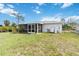 Expansive backyard view showcasing the screened-in porch, providing a relaxing outdoor space at 2341 Sheila Ln, North Port, FL 34286