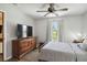 Bright bedroom featuring a ceiling fan, large window, and wood-look floors at 2341 Sheila Ln, North Port, FL 34286