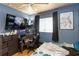 Bedroom with blue walls, a ceiling fan and a desk with monitors at 2341 Sheila Ln, North Port, FL 34286