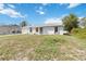 Charming home with a well-maintained lawn and a neutral color scheme, creating a welcoming curb appeal at 2341 Sheila Ln, North Port, FL 34286