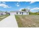 Charming one-story home with a well-manicured lawn, an attached garage, and inviting curb appeal at 2341 Sheila Ln, North Port, FL 34286