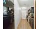 Galley kitchen with dark cabinets, wood-look flooring, and stainless steel appliances at 2341 Sheila Ln, North Port, FL 34286