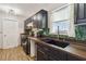 Charming kitchen featuring dark cabinets, stylish backsplash, wooden countertop and modern appliances at 2341 Sheila Ln, North Port, FL 34286