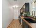 Long kitchen featuring dark cabinets, stylish backsplash, wooden countertop and modern appliances at 2341 Sheila Ln, North Port, FL 34286