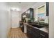 Kitchen featuring black appliances, dark cabinets, stylish backsplash, wooden countertop and hardwood floors at 2341 Sheila Ln, North Port, FL 34286