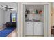 Laundry closet equipped with a washer, dryer, and shelving for storage solutions at 2341 Sheila Ln, North Port, FL 34286