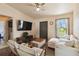 Bright living room featuring stylish furniture, a ceiling fan, and a view of the outdoors at 2341 Sheila Ln, North Port, FL 34286