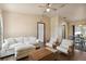 Cozy living room with a sofa, chairs, hardwood floors, and access to a dining area at 2341 Sheila Ln, North Port, FL 34286