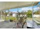 Screened patio with patio furniture, offering a view of the landscaped backyard at 2341 Sheila Ln, North Port, FL 34286