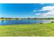 Waterfront backyard with well-manicured lawn and lake views at 24065 Canterwood Way, Venice, FL 34293