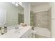Bright bathroom with white vanity, tub-shower combo, and stylish decorative touches at 24065 Canterwood Way, Venice, FL 34293