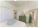 Bright bedroom with ceiling fan, closet and bathroom access, and a tall mirror at 24065 Canterwood Way, Venice, FL 34293