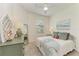 Well lit bedroom featuring neutral walls, a ceiling fan, and coastal decor at 24065 Canterwood Way, Venice, FL 34293