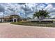 Sarasota National community entrance with manicured landscaping and a brick-paved drive at 24065 Canterwood Way, Venice, FL 34293