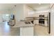 A bright kitchen featuring granite countertops, stainless steel appliances, and ample cabinet space at 24065 Canterwood Way, Venice, FL 34293