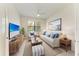 Cozy living room with neutral decor, a ceiling fan, and lots of natural light at 24065 Canterwood Way, Venice, FL 34293