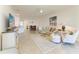 An open-concept living room and dining area with neutral tones, tile floors, and ample natural light at 24065 Canterwood Way, Venice, FL 34293